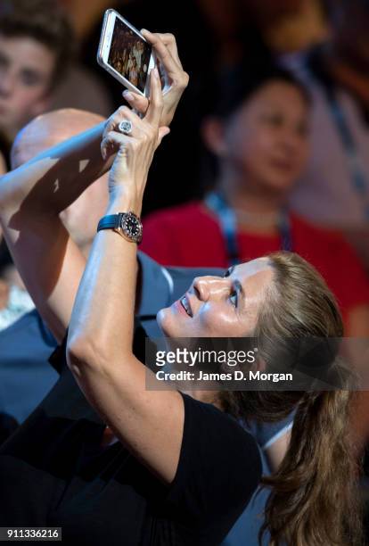 Mirka Federer takes a selfie whilst watching the trophy presentation as husband Roger Federer wins the mens singles on day 14 of the 2018 Australian...