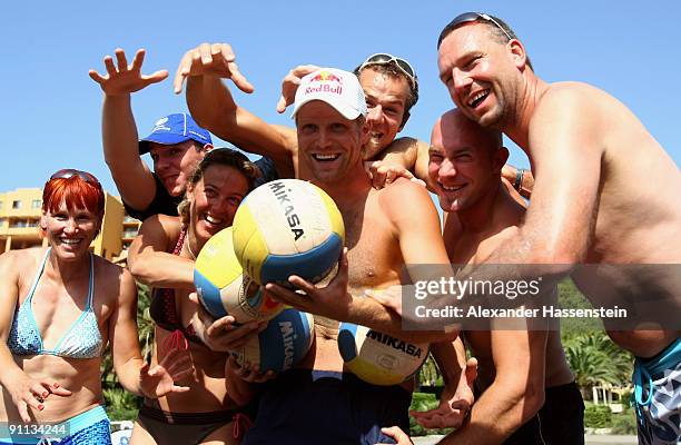 Beach volleyball World Champion Julius Brink poses prior to a fun beach volleyball match against 6 World Champions and Olympic medalist Kati Wilhelm,...