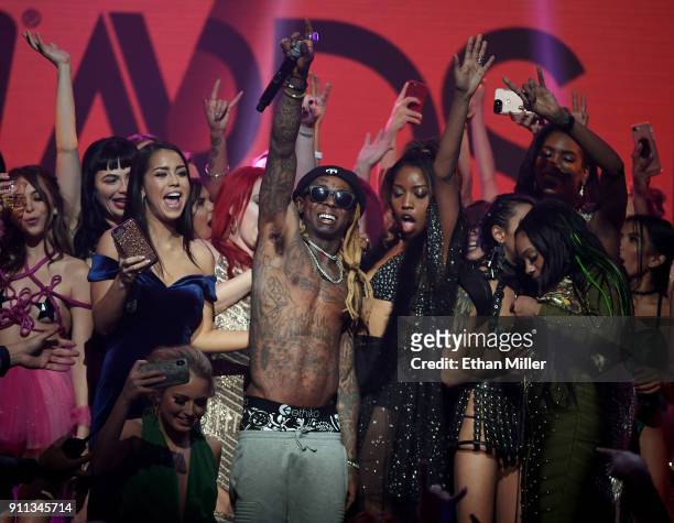 Audience members join rapper Lil' Wayne onstage as he performs during the 2018 Adult Video News Awards at The Joint inside the Hard Rock Hotel &...