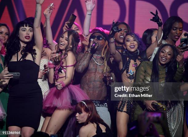 Audience members join rapper Lil' Wayne onstage as he performs during the 2018 Adult Video News Awards at The Joint inside the Hard Rock Hotel &...