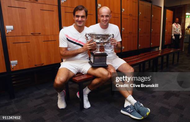 Roger Federer of Switzerland and coach Ivan Ljubicic pose with the Norman Brookes Challenge Cup in the players locker room after winning the Men's...