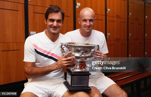 Roger Federer of Switzerland and coach Ivan Ljubicic pose with the Norman Brookes Challenge Cup in the players locker room after winning the Men's...