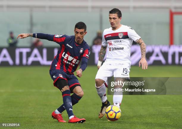 Adrian Stoian of Crotone competes for the ball with Fabio Pisacane of Cagliari during the serie A match between FC Crotone and Cagliari Calcio at...