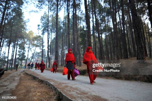 Nepalese Hindu woman arives on a bare foot for the ritual procession at Changu Narayan Temple, Bhaktapur during Madhav Narayan Festival or Swasthani...