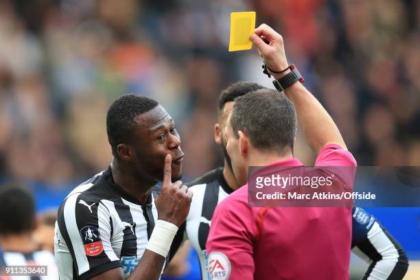 Referee Kevin Friend shows.a yellow card to Chancel Mbemba of Newcastle United during the FA Cup 4th Round match between Chelsea and Newcastle United...
