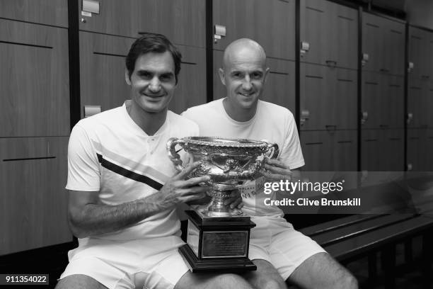 Roger Federer of Switzerland and coach Ivan Ljubicic pose with the Norman Brookes Challenge Cup in the players locker room after winning the Men's...