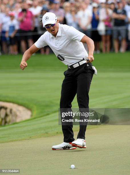 Haotong Li of China celebrates his birdie and victory on the 18th green during the final round on day four of the Omega Dubai Desert Classic at...