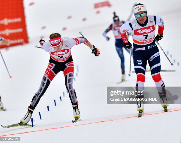 Teresa Stadlober of Austria and Marit Bjoergen of Norway compete during the Ladies FIS Cross Country 10 km Mass Start World Cup on January 28, 2018...