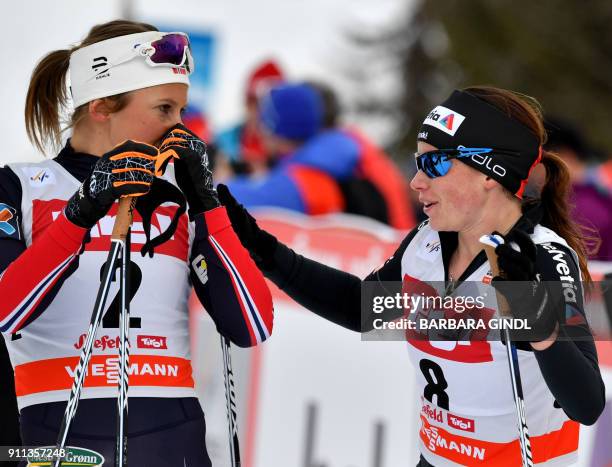 Ingvild Flugstad Oestberg of Norway and Nathalie Von Siebenthal of Switzerland react after the Ladies FIS Cross Country 10 km Mass Start World Cup on...