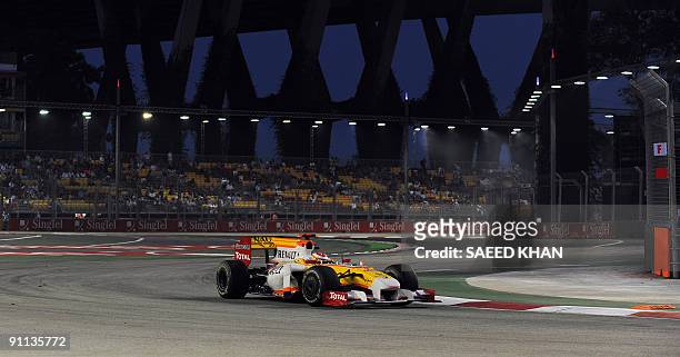 Spanish Formula One driver Fernando Alonso of Renault powers his car during a practice session for the Singapore Grand Prix on the Marina Bay City...