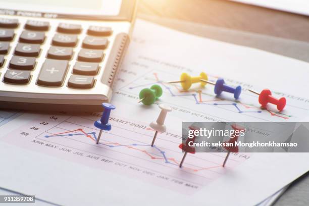 close up of pin on graph data. business finance concept. - accounting services stock pictures, royalty-free photos & images
