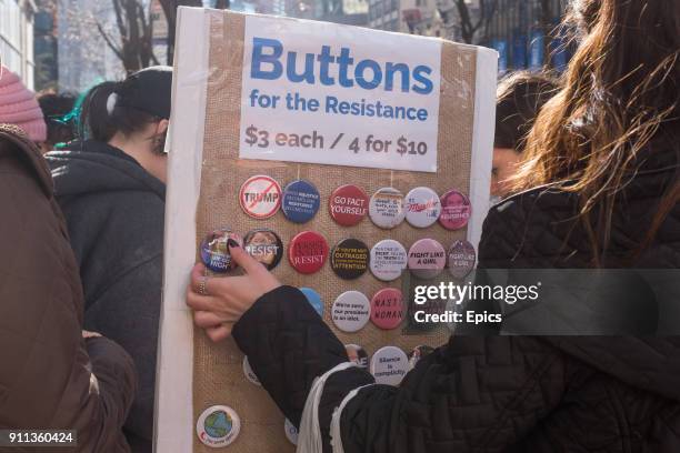 Political pins and badges are on sale during the Women's March in New York City, January 20th 2018. Hundreds of thousands of women marched in protest...