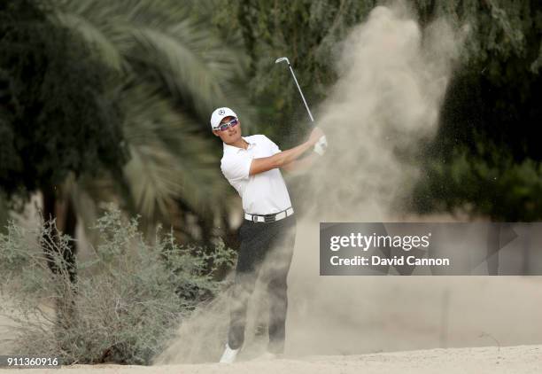 Haotong Li of China plays his second shot on the par 4, 14th hole during the final round of the Omega Dubai Desert Classic on the Majlis Course at...