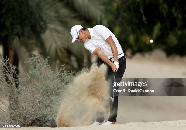 Haotong Li of China plays his second shot on the par 4, 14th hole during the final round of the Omega Dubai Desert Classic on the Majlis Course at...
