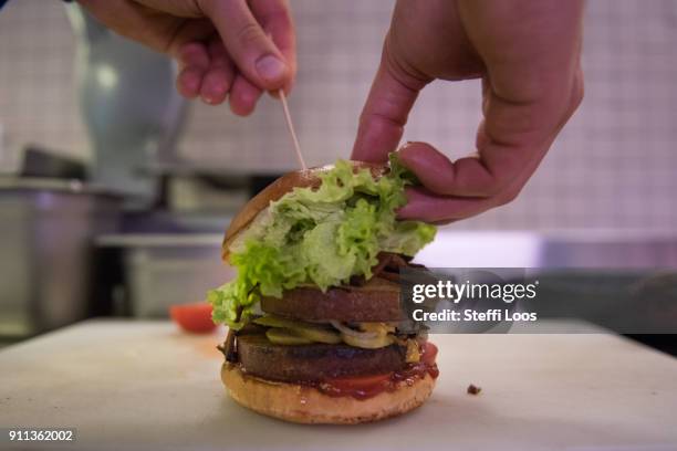Vegan burger is displayed at the vegan seitan manufactory shop and diner L'herbivore by owner Johannes Theuerl on January 25, 2018 in Berlin,...