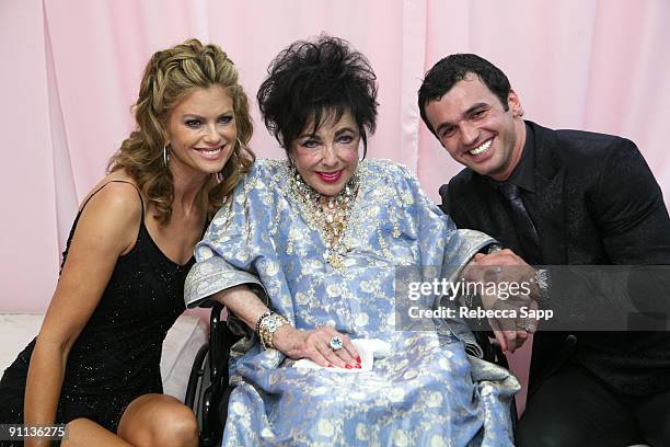 Model Kathy Ireland, Dame Elizabeth Taylor, and dancer Tony Dovolani pose backstage during the Macy's Passport gala held at Barker Hangar on...