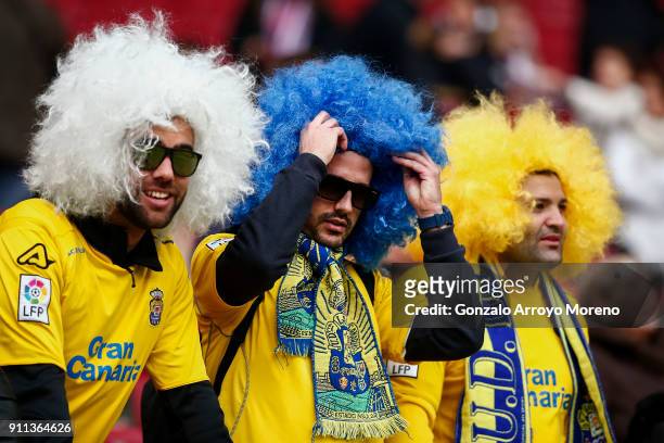Las Palmas fans wearing wigs have fun from the grandstands before the La Liga match between Club Atletico Madrid and UD Las Palmas at Estadio Wanda...