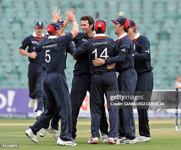 England bowler Graham Onions celebrates with teammates after he took the wicket of Sri Lankan batsman Sanath Jayasuriya, for a duck during the ICC...