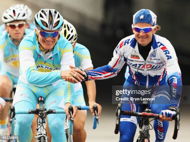 Alexandre Vinokourov of Kazachstan shakes hands with Alexander Botcharov of Russia during training for the 2009 UCI Road World Championships on...