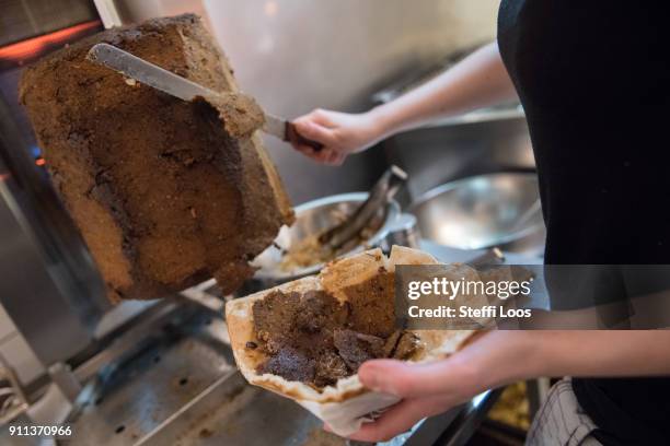 Employees prepare vegan doner plate at vegan bistro Voener on January 25, 2018 in Berlin, Germany. Voener offers classic fast food dishes such as...