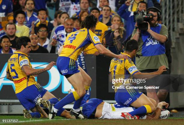 Jarryd Hayne attempts to stop Bryson Goodwin of the Bulldogs from scoring a try during the first NRL Preliminary Final match between the Bulldogs and...