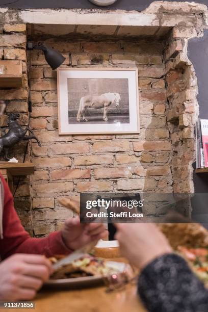 Guests eat a vegan doner plate and a doner kebab at vegan bistro Voener on January 25, 2018 in Berlin, Germany. Voener offers classic fast food...