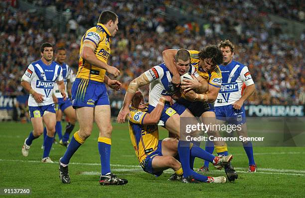 Andrew Ryan of the Bulldogs is tackled during the first NRL Preliminary Final match between the Bulldogs and the Parramatta Eels at ANZ Stadium on...