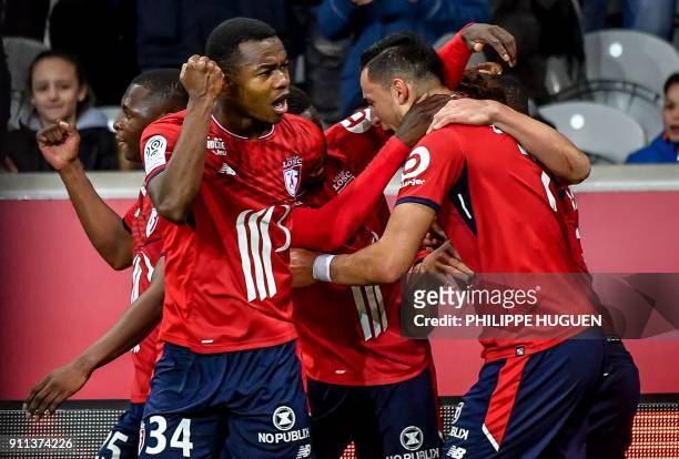 Lille's Dutch-Morrocan forward Anwar El-Ghazi is congratuled by teammates after scoring a goal during the French L1 football match between Lille and...