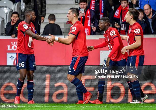 Lille's Dutch-Morrocan forward Anwar El-Ghazi is congratuled by teammates after scoring a goal during the French L1 football match between Lille and...