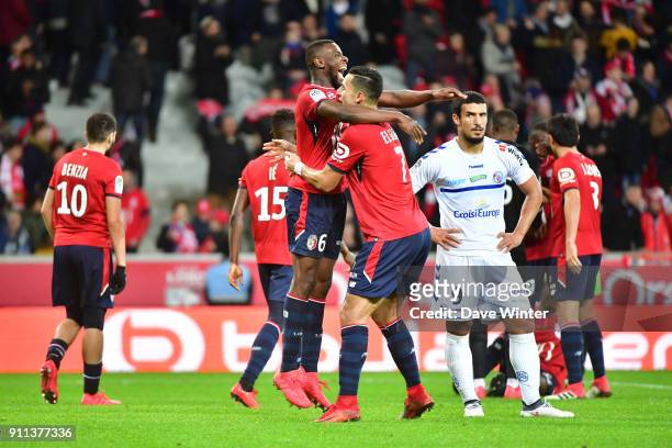 Idriss Saadi of Strasbourg looks on as captain Ibrahim Amadou of Lille and Anwar El Ghazi of Lille celebrate their last minute win in the Ligue 1...
