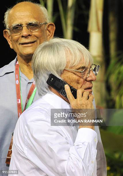 Formula One ringmaster Bernie Ecclestone talks on his mobile phone during the first practice session for the 2009 Singapore Formula One Grand Prix in...