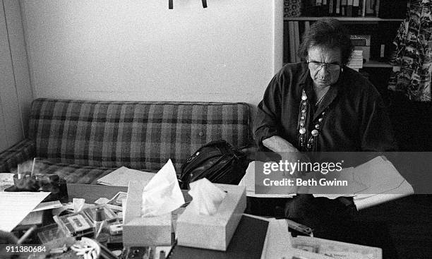 Country singer and songwriter Johnny Cash goes over music in Jack Clement's office on September 6, 1990 in Nashville, Tennessee.