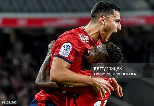 Lille's Portuguese defender Edgar Ie is congratuled by Lille's Dutch-Morrocan forward Anwar El-Ghazi after scoring a goal during the French L1...