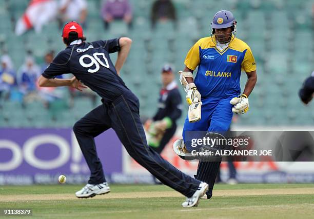 Sri Lanka's cricketer Thilina Kandamby makes a run as England fielder Graham Onions tries to catch him out during the ICC Champions Trophy group...