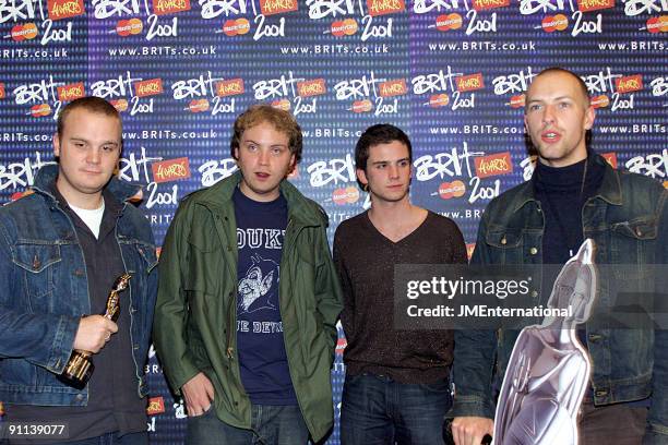 Photo of COLDPLAY, L-R: Will Champion, Jonny Buckland, Guy Berryman, Chris Martin - posed, group shot, holding Brit Award