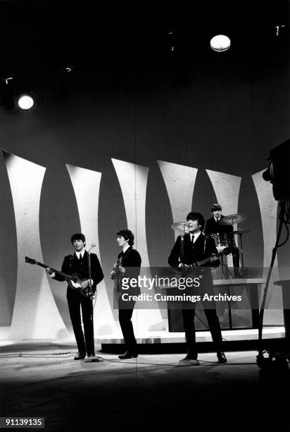 View of the members of British Rock group the Beatles as they perform onstage for 'The Ed Sullivan Show' at CBS's Studio 50, New York, New York,...