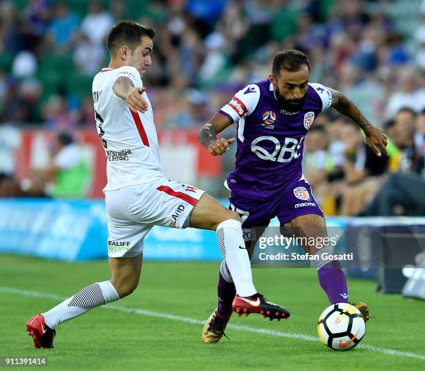 Diego Castro of the Glory competes for the ball against Steven Lustica of the Wanderers during the round 18 A-League match between the Perth Glory...