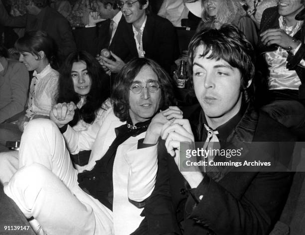 Photo of Yoko ONO and Paul McCARTNEY and John LENNON and BEATLES; L-R. Yoko Ono, John Lennon, Paul McCartney in the audience at the London Pavillion...