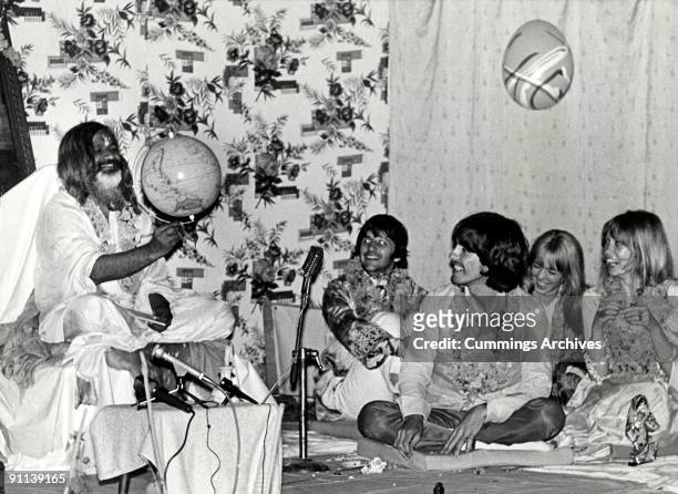 Photo of BEATLES and MAHARISHI MAHESH YOGI and Ringo STARR and George HARRISON; L-R. Maharishi Mahesh Yogi, George Harrison, Ringo Starr at a party...