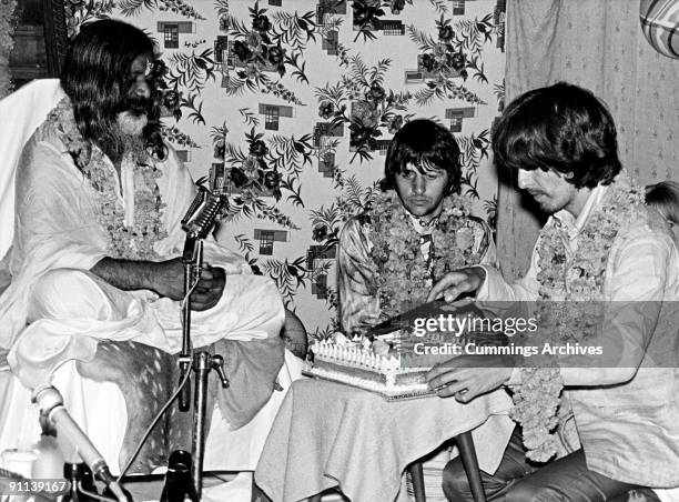 Photo of MAHARISHI MAHESH YOGI and George HARRISON and Ringo STARR and BEATLES; L-R: Maharishi Mahesh Yogi, Ringo Starr, George Harrison at a party...