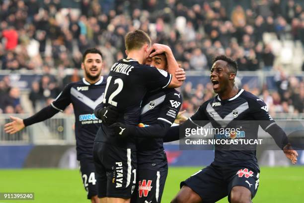 Bordeaux's Brazilian forward Malcom celebrates with teammates after scoring a goal during the French Ligue 1 football match between Bordeaux and Lyon...