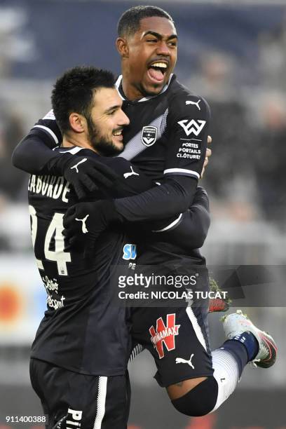 Bordeaux's French forward Gaetan Laborde celebrates after scoring a goal from a penalty with Bordeaux's Brazilian forward Malcom during the French...
