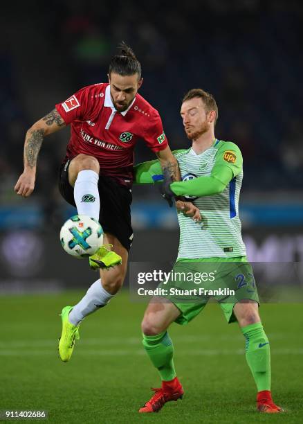 Maximilian Arnold of Wolfsburg is challenged by Martin Harnik of Hannover during the Bundesliga match between Hannover 96 and VfL Wolfsburg at...