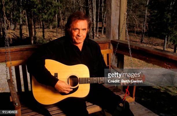 Photo of Johnny CASH, Posed portrait of Johnny Cash with Takamine acoustic guitar