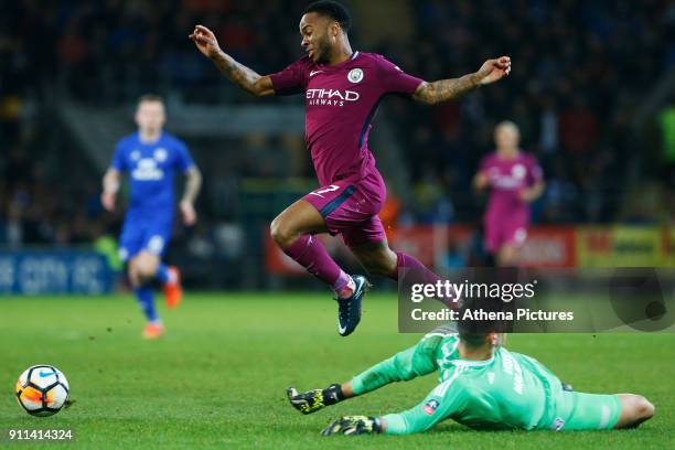 Raheem Sterling of Manchester City leaps over Neil Etheridge of Cardiff City during the Fly Emirates FA Cup Fourth Round match between Cardiff City...