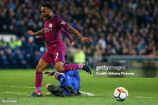 Raheem Sterling of Manchester City is tackled by Sean Morrison of Cardiff City during the Fly Emirates FA Cup Fourth Round match between Cardiff City...