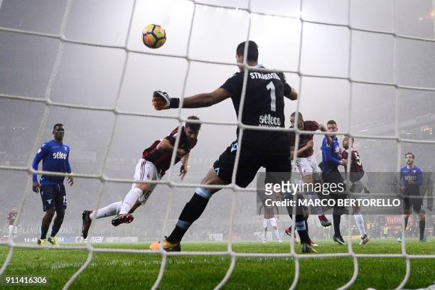 Milan's forward Patrick Cutrone scores against Lazio's goalkeeper from Albania Thomas Strakosha during the Italian Serie A football match AC Milan Vs...