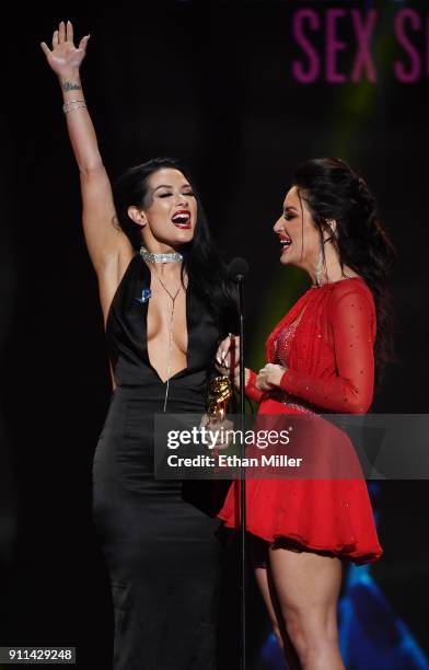 Adult film actresses Katrina Jade and Kissa Sins react after winning the award for Best Girl/Girl Sex Scene during the 2018 Adult Video News Awards...