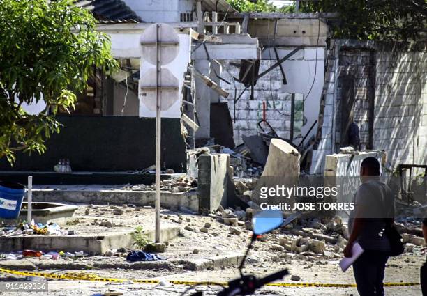 Man walks in front a police station after a bomb attack where 5 died and 41 are wounded in Soledad Atlantico Dapartment, Colombia, on January 28...