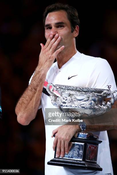 An emotional Roger Federer of Switzerland poses with the Norman Brookes Challenge Cup after winning the 2018 Australian Open Men's Singles Final...